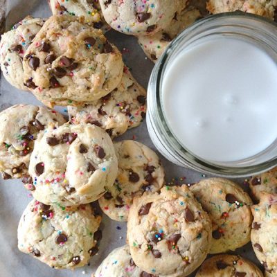 Birthday cake cookies with glass of milk on tray