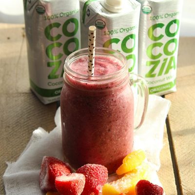 Cocozia coconut water smoothie in mason jar with straw on counter