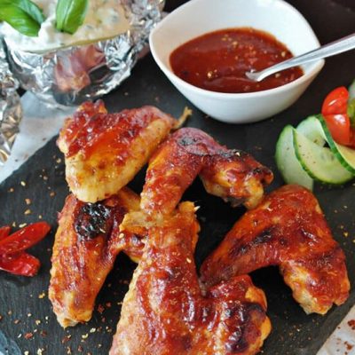 chicken wings on counter with dipping hot sauce