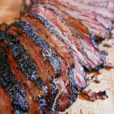 slice brisket on wood cutting board