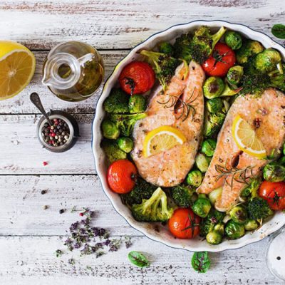 baked salmon steaks with vegetables in bowl