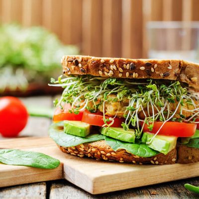 Avocado chickpeas sandwich on wood board